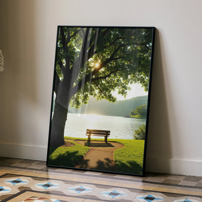 Vertical poster wall art featuring a sunlit tree and bench by a serene lakeside path.