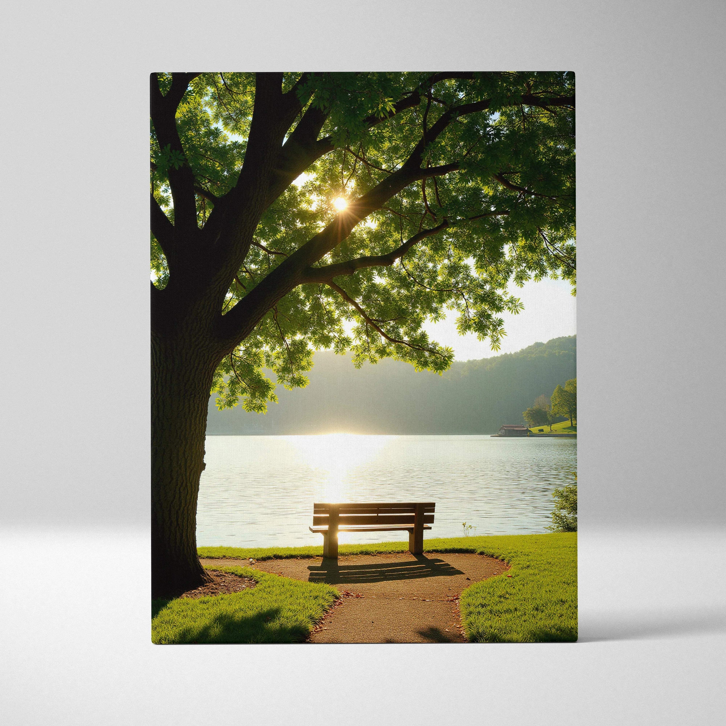Canvas wall art featuring a serene lakeside scene with a bench under a large tree at sunset.