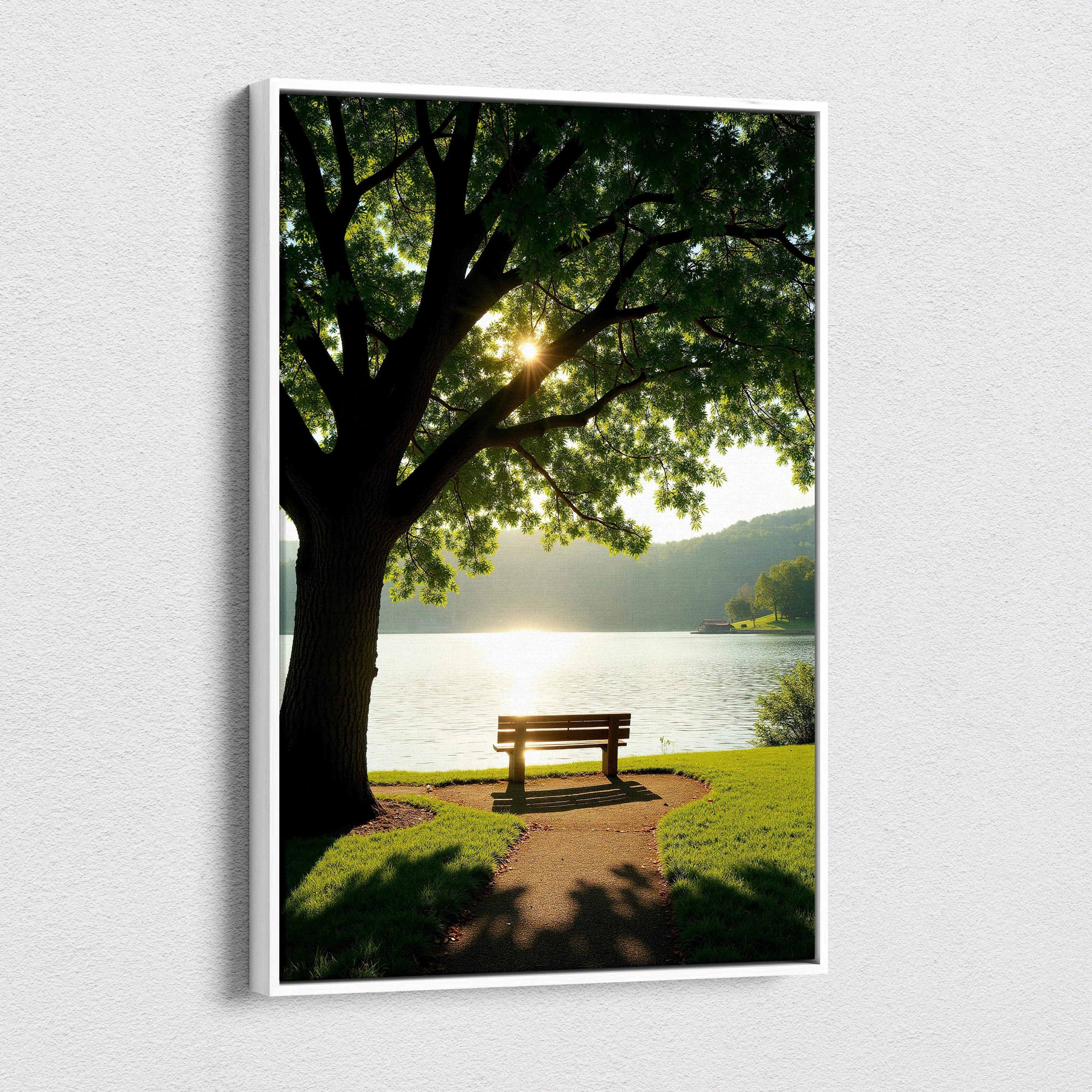 Canvas wall art of a serene lakeside bench under a large leafy tree with sunlight filtering through the branches.