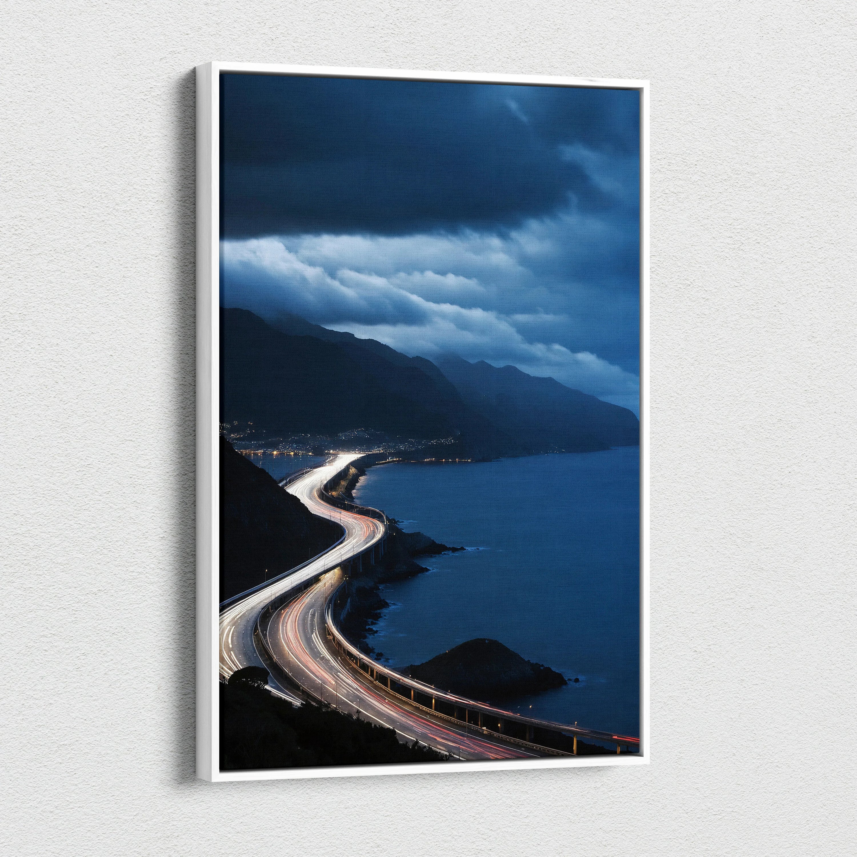Vertical canvas wall art featuring a vibrant city night sky with winding coastal highway lights and dramatic clouds.