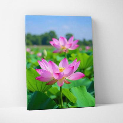 Vibrant floral canvas wall art featuring pink lotus flowers against green leaves and blue sky background.