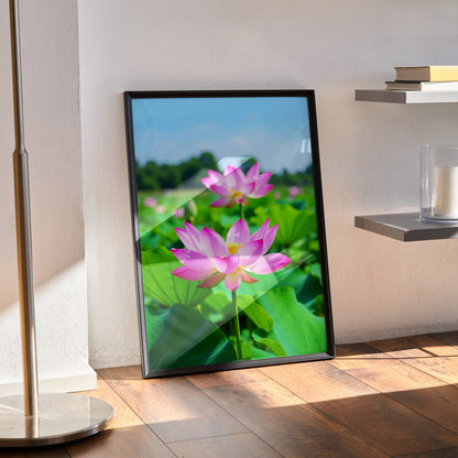 Vibrant floral nature poster with pink lotus flowers and green leaves in vertical wall art frame.