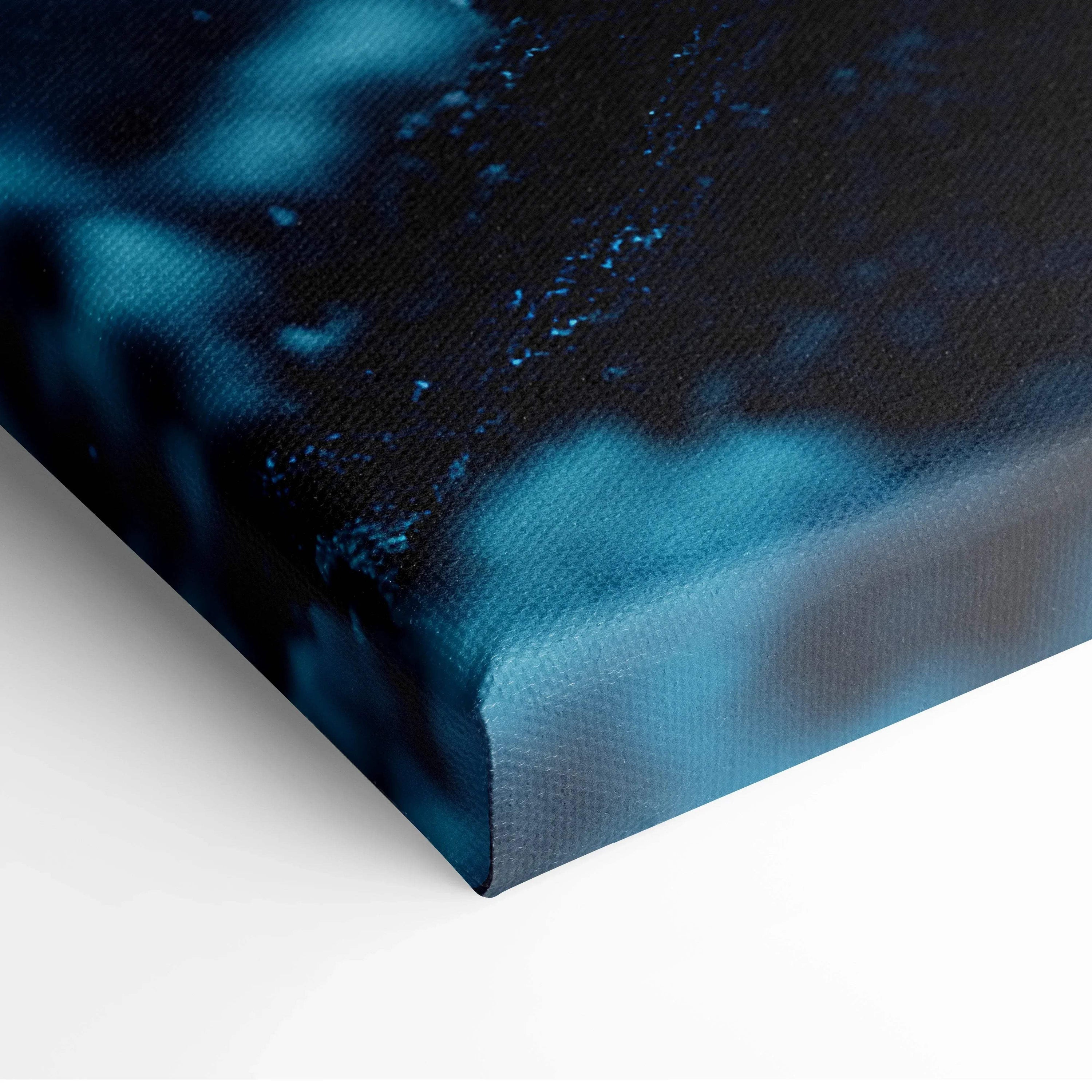 Close-up of blue and black vibrant floral digital art on textured canvas wall art with wrapped edges.