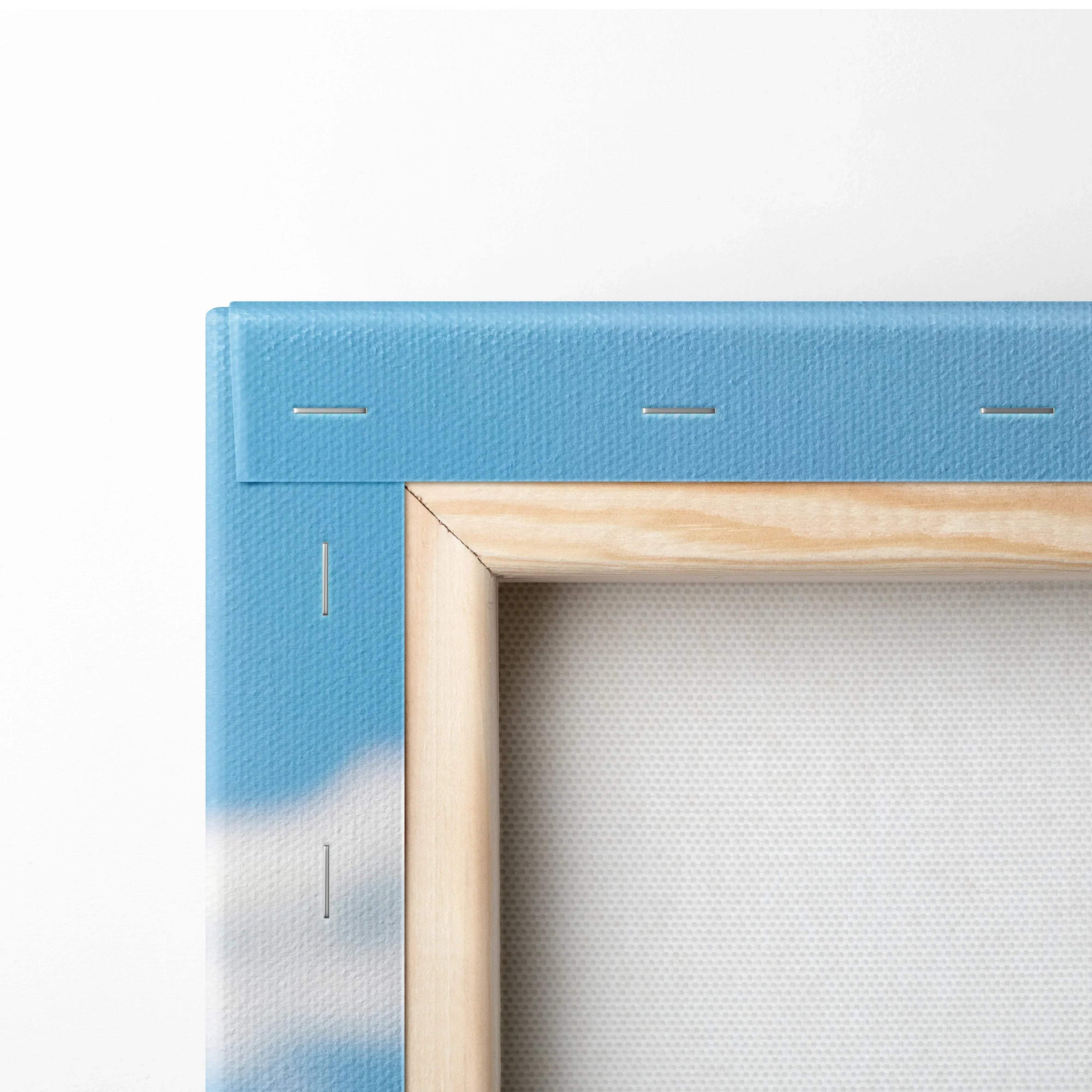 Close-up of canvas wall art corner with wooden frame and blue spray paint detail.