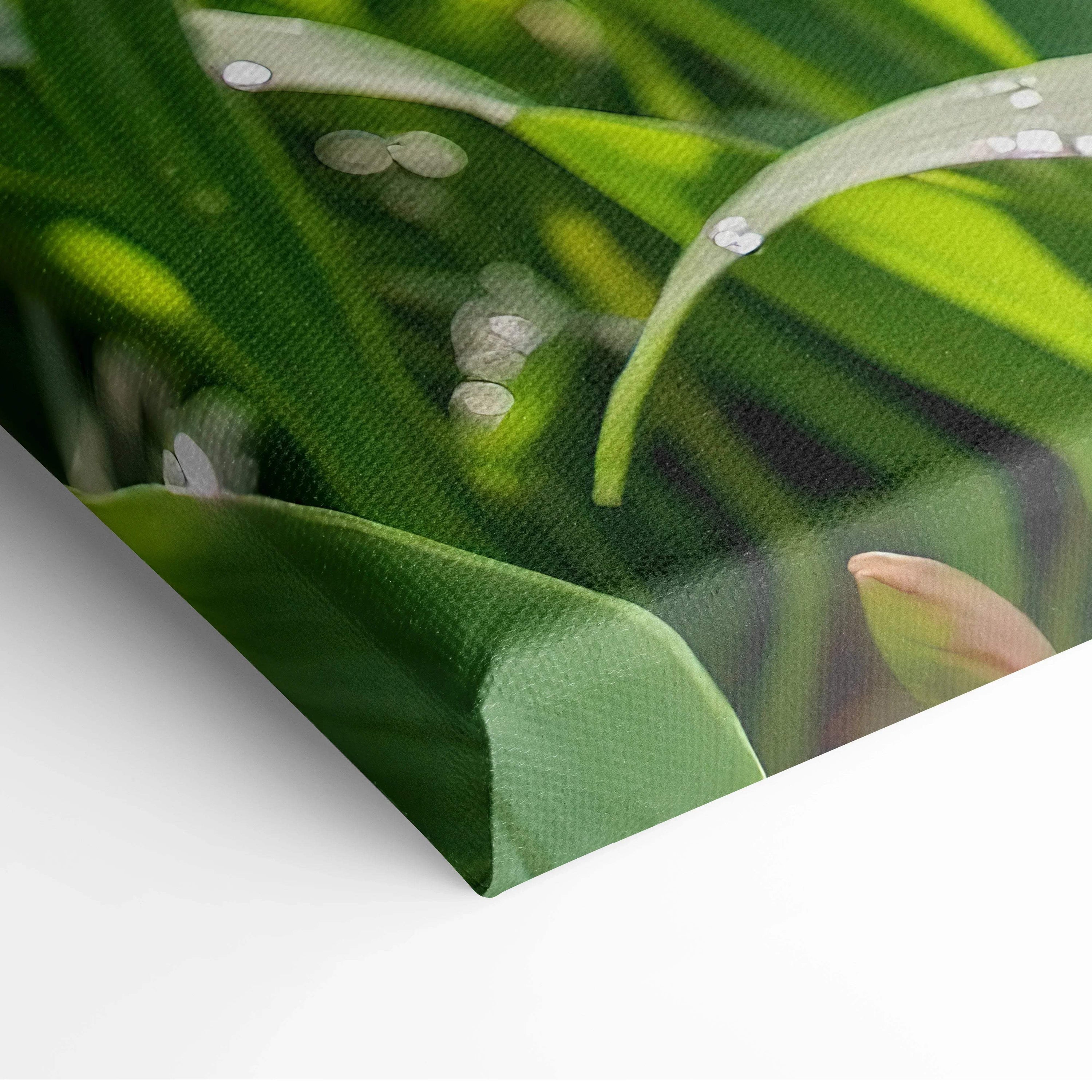 Close-up of vibrant green and white floral canvas wall art with textured brushstroke details.