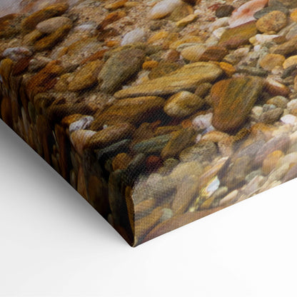 Motivational ocean wave canvas wall art featuring textured smooth river stones in earthy tones for coastal decor