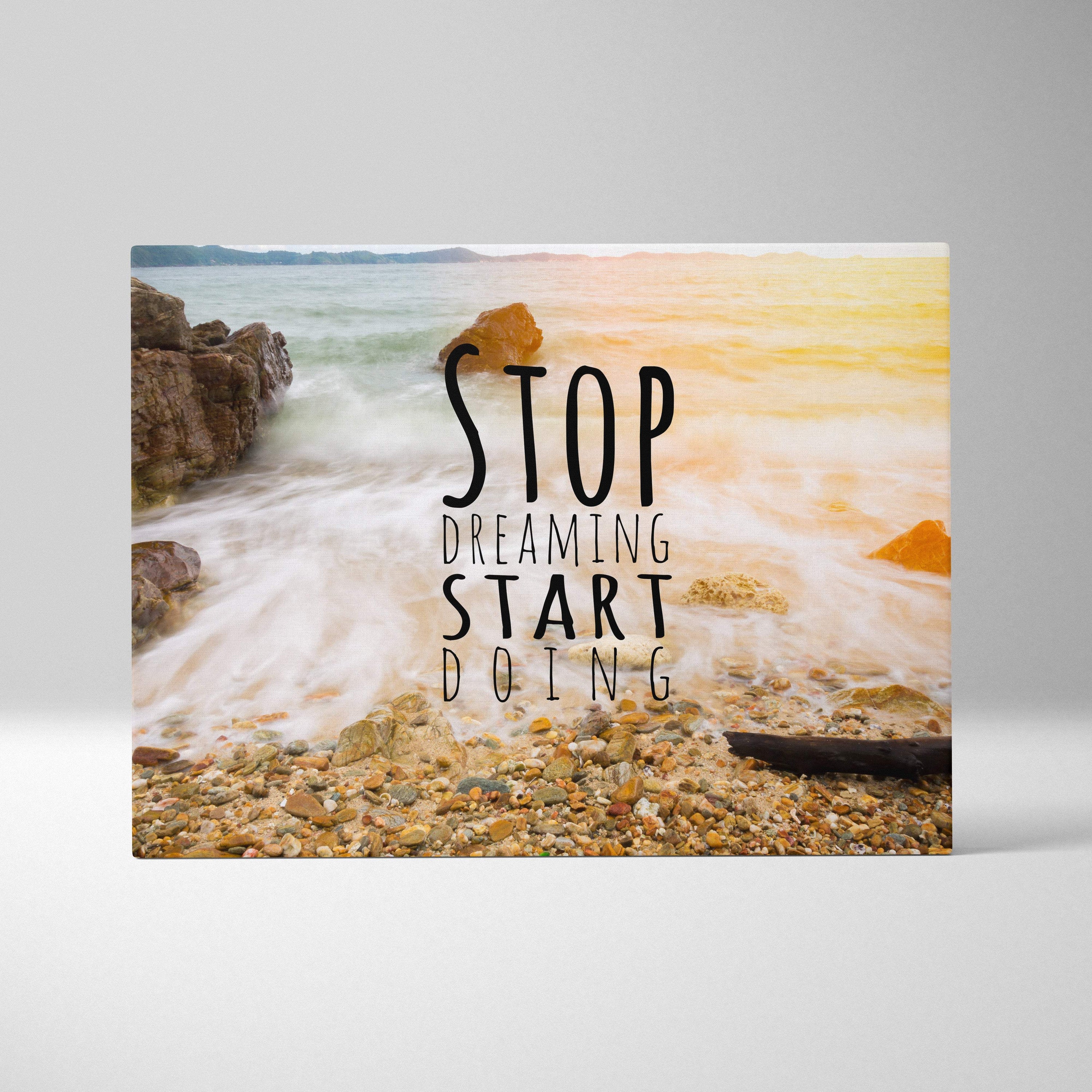 Motivational ocean wave canvas wall art with serene beach scene and black text stop dreaming start doing in coastal decor