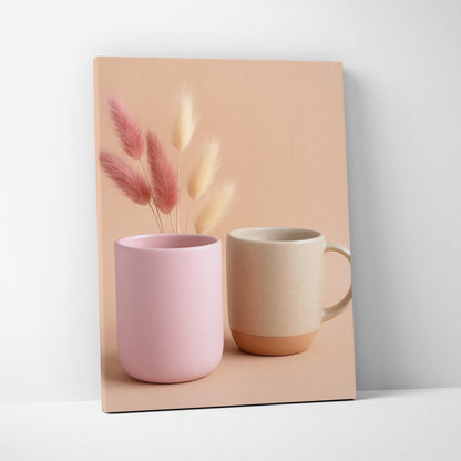 Canvas wall art featuring minimalistic still life with pink and beige ceramic mugs and soft dried floral stems on a neutral.