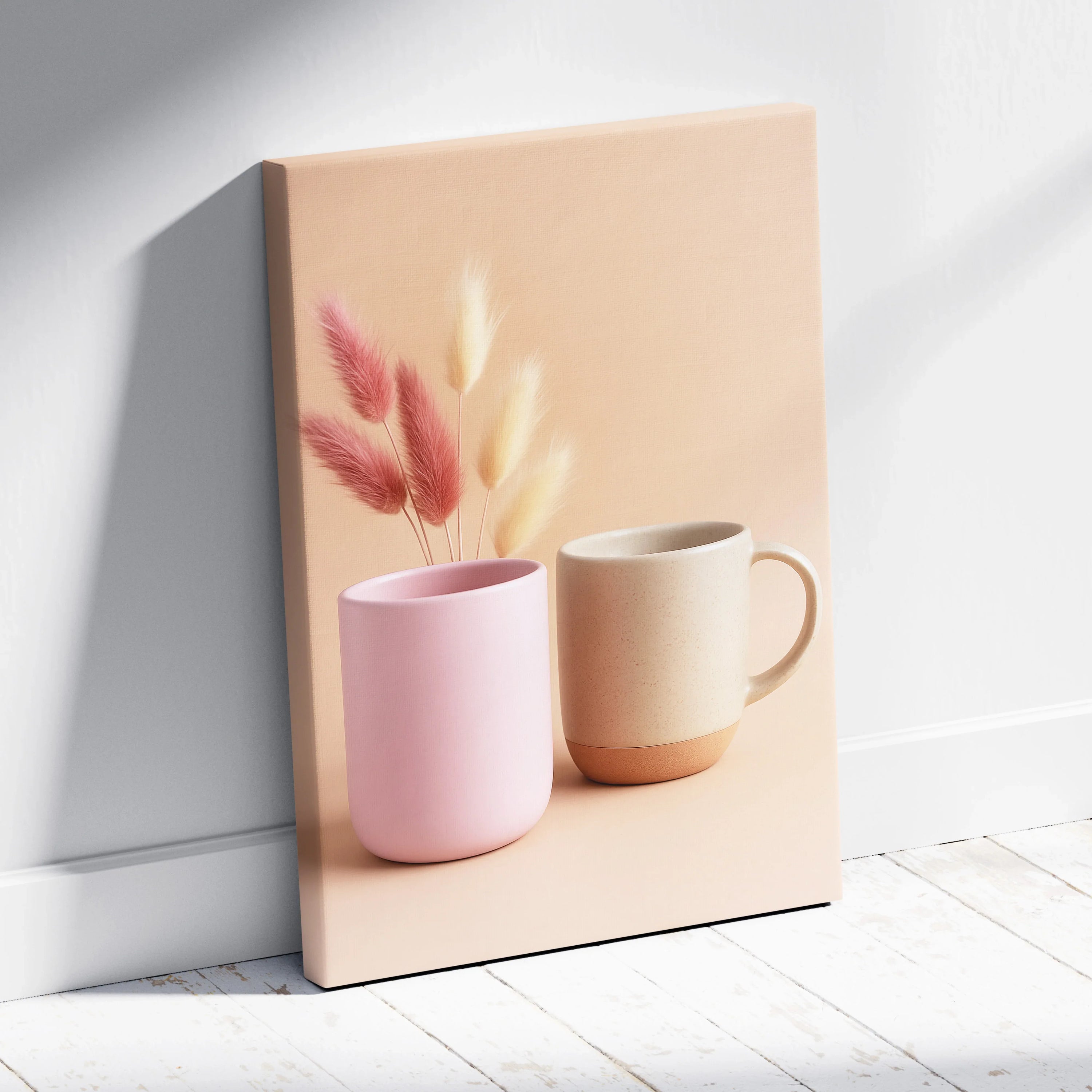 Canvas wall art featuring minimalist still life with pink and beige ceramic mugs and soft pampas grass against a blush.