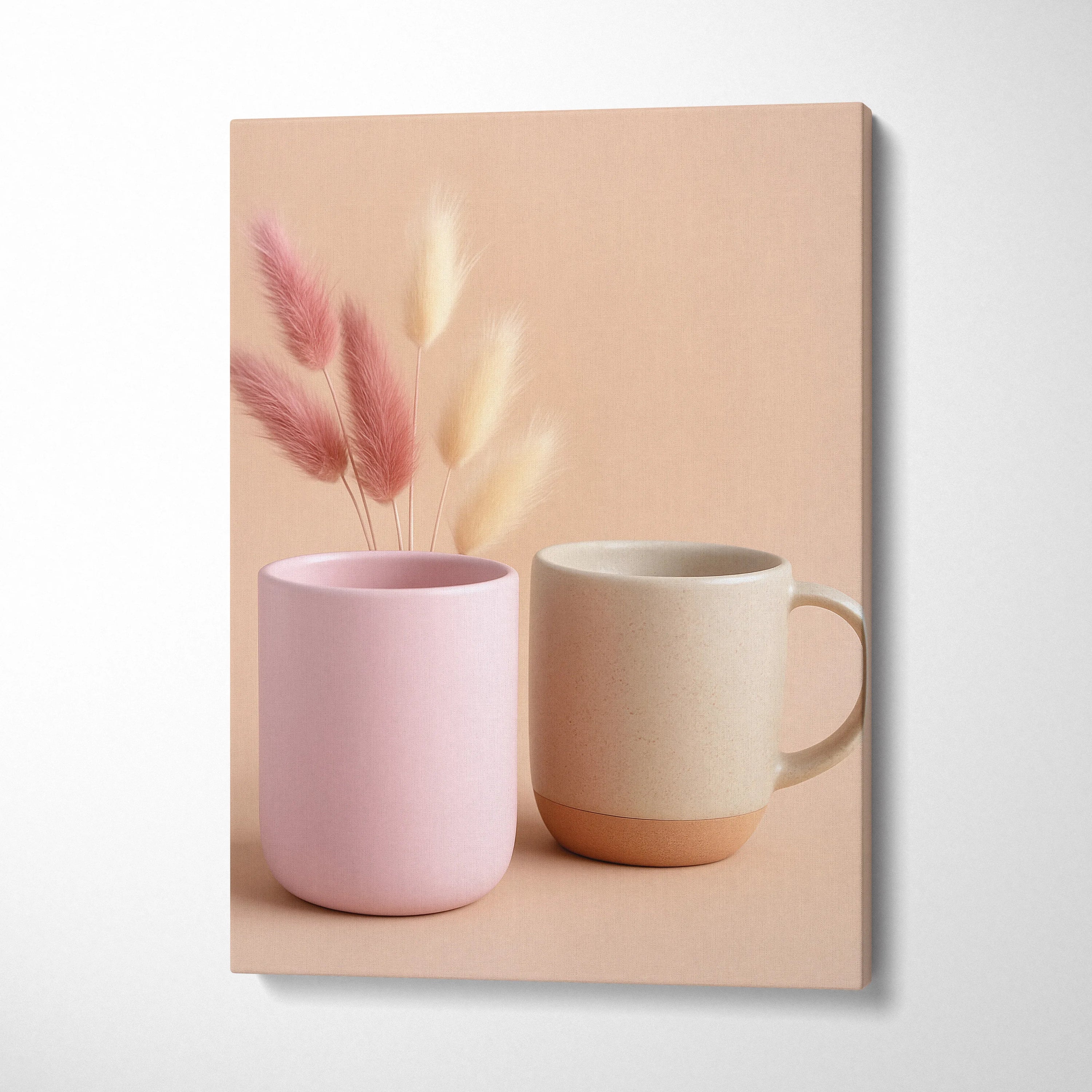 Canvas wall art featuring a pink vase and beige mug with soft dried floral stems on a neutral background.