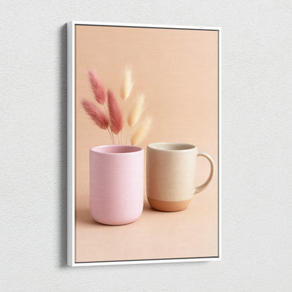 Canvas wall art featuring minimalist pink and beige ceramic mugs with dried floral stems on soft peach background.