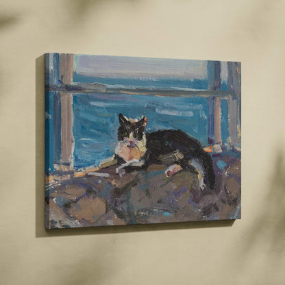 A framed oil painting of a black and white cat resting on stone near blue water in impressionist style canvas print