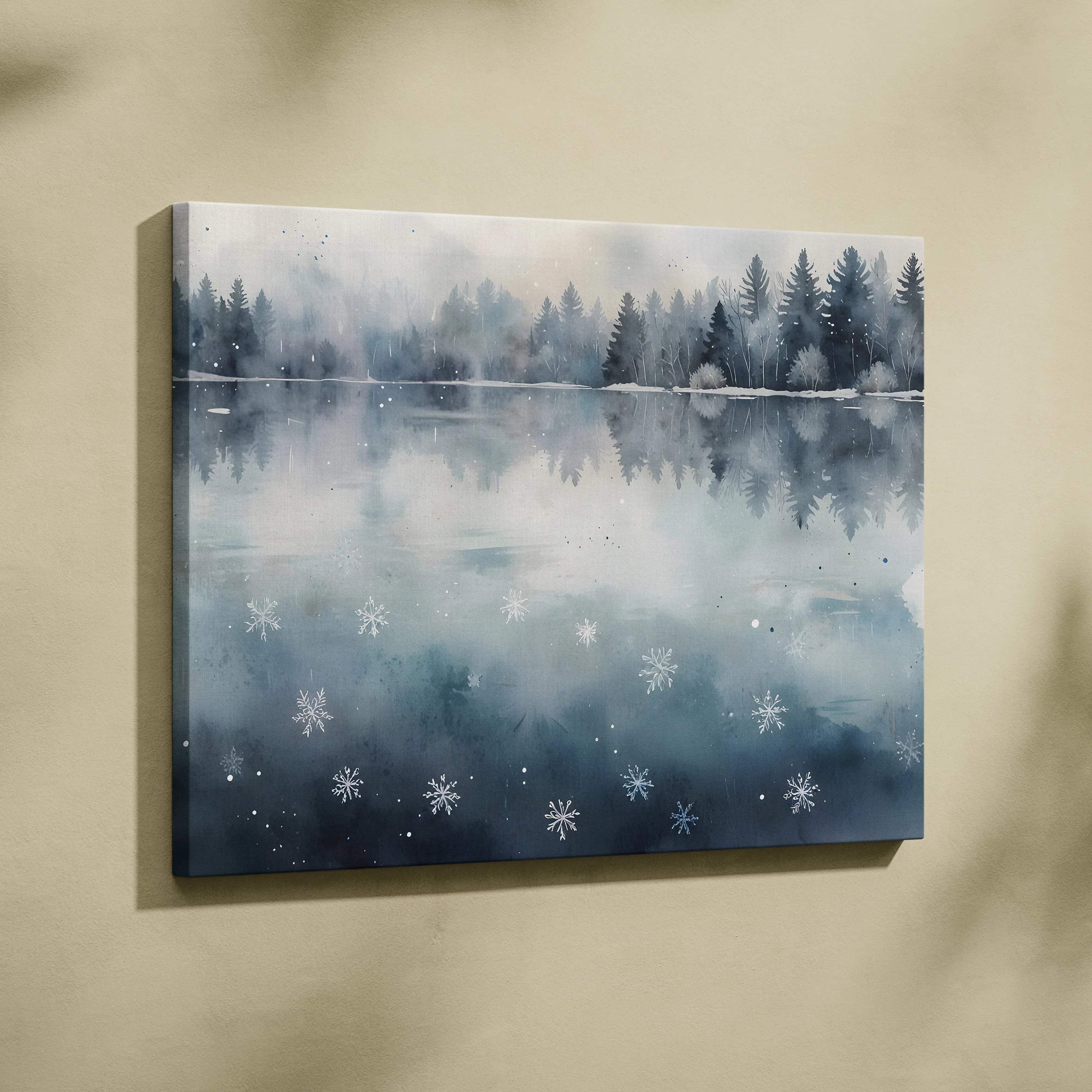 Canvas wall art featuring a serene snowy landscape with pine trees reflected on a calm lake and watercolor snowflakes.