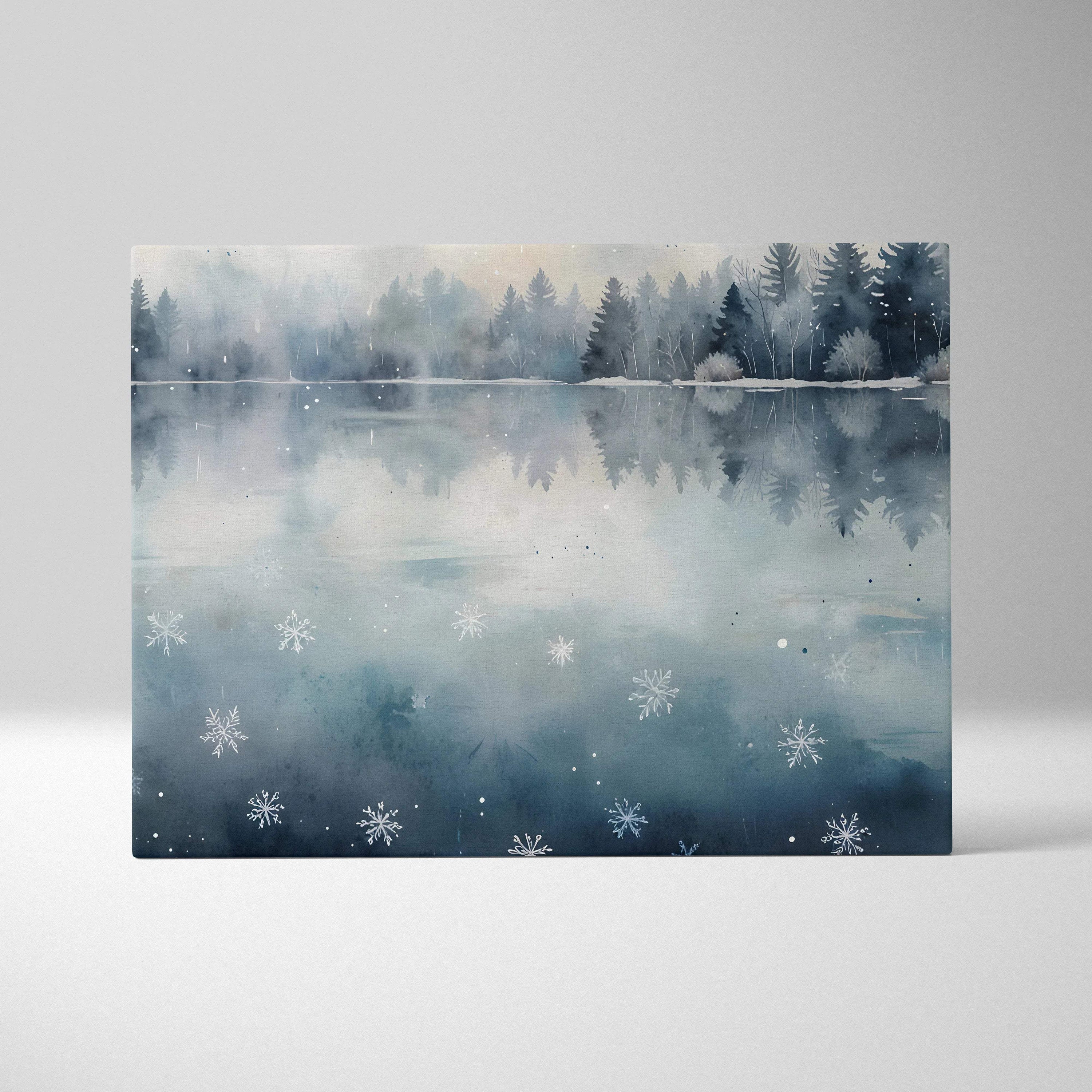 Canvas wall art featuring a serene snowy forest reflected on a misty lake with delicate snowflakes.