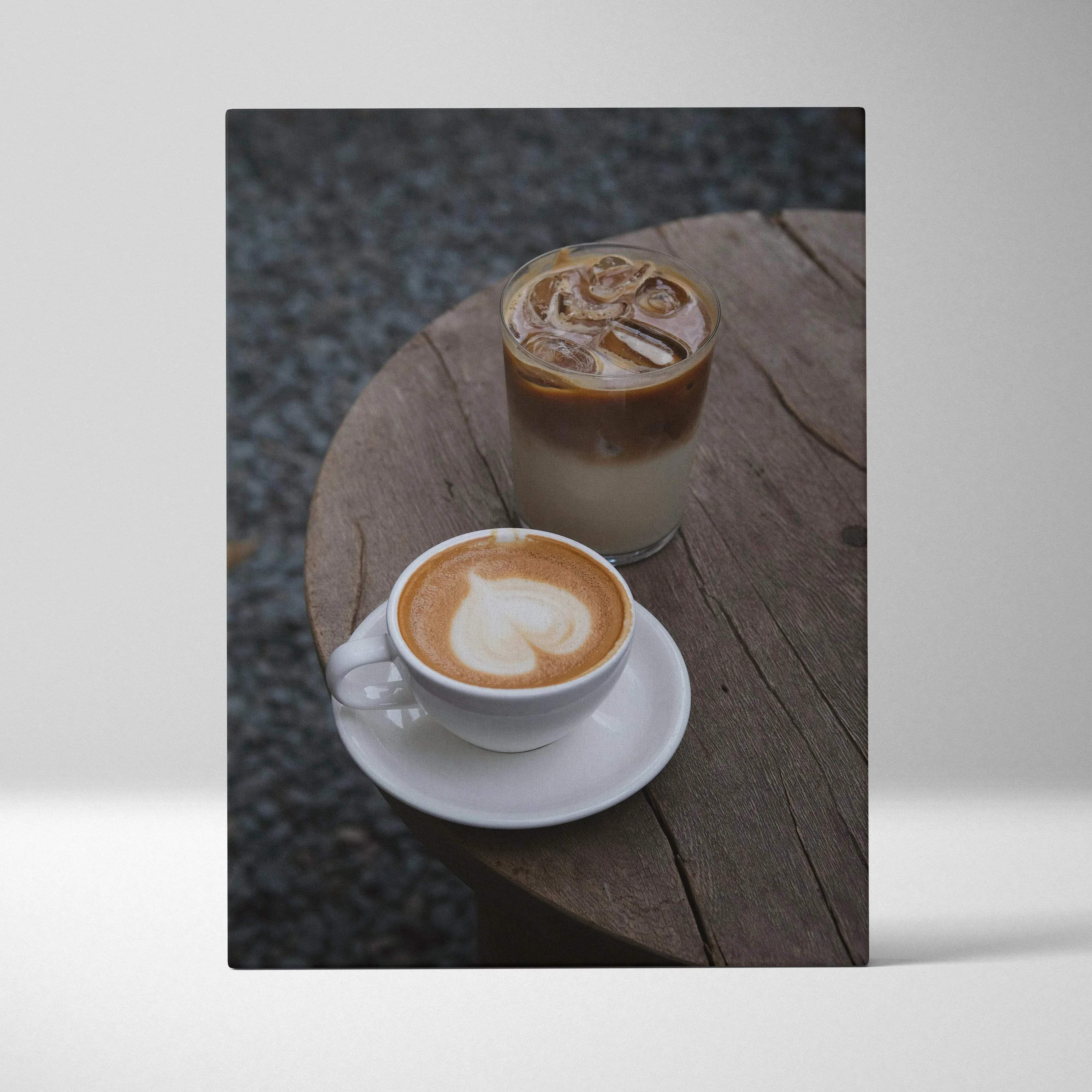 Cozy coffee moment canvas wall art featuring white ceramic coffee cup with latte art and iced coffee in warm tones