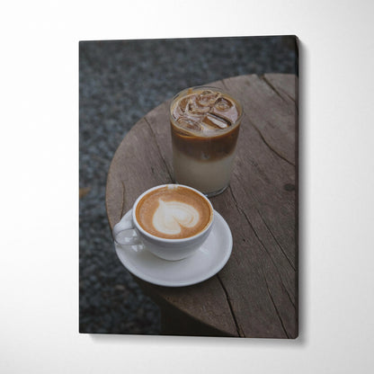 Vertical canvas wall art featuring digital art of two coffee drinks on a rustic wooden table.
