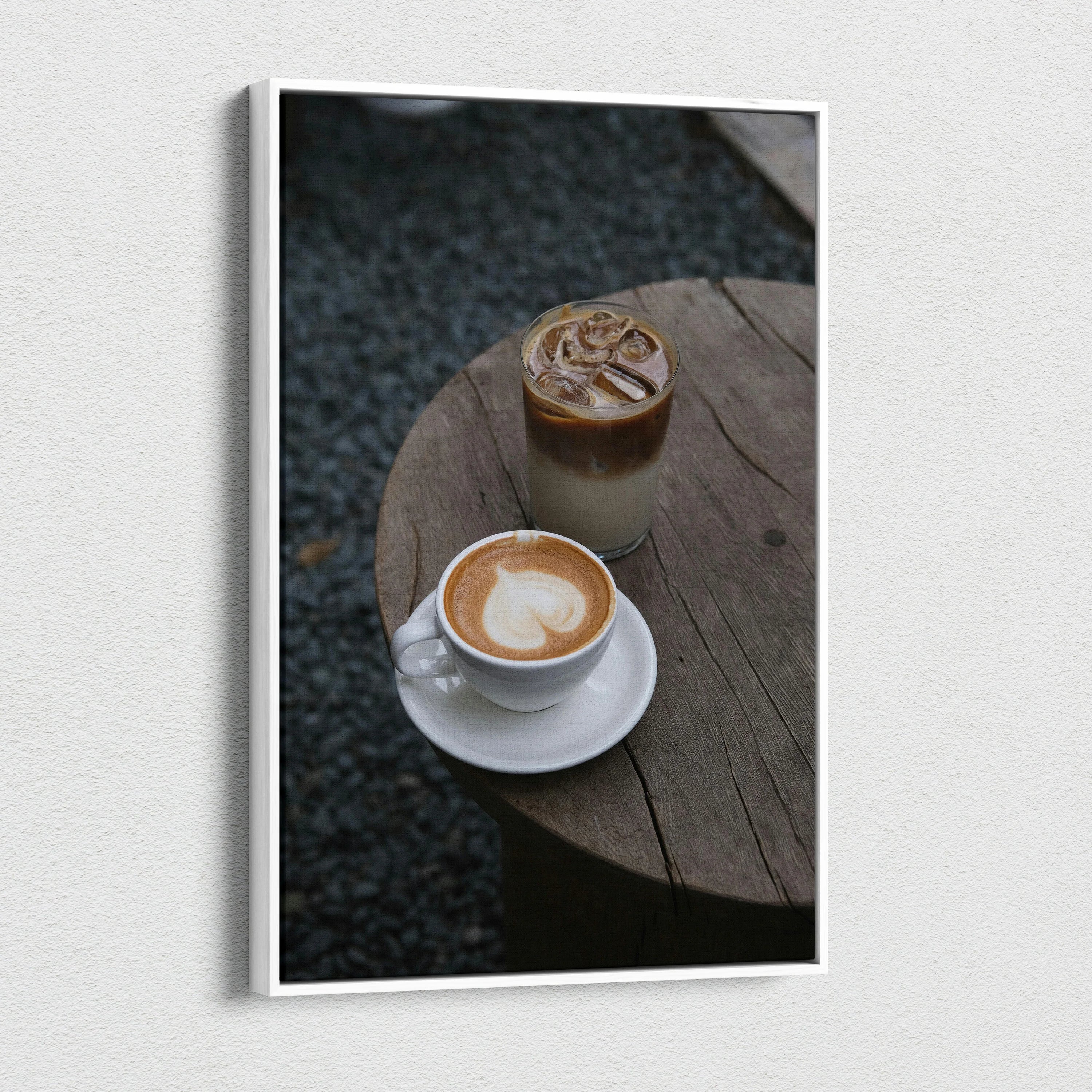 Coffee latte and iced coffee on round wooden table canvas wall art print in vertical orientation.