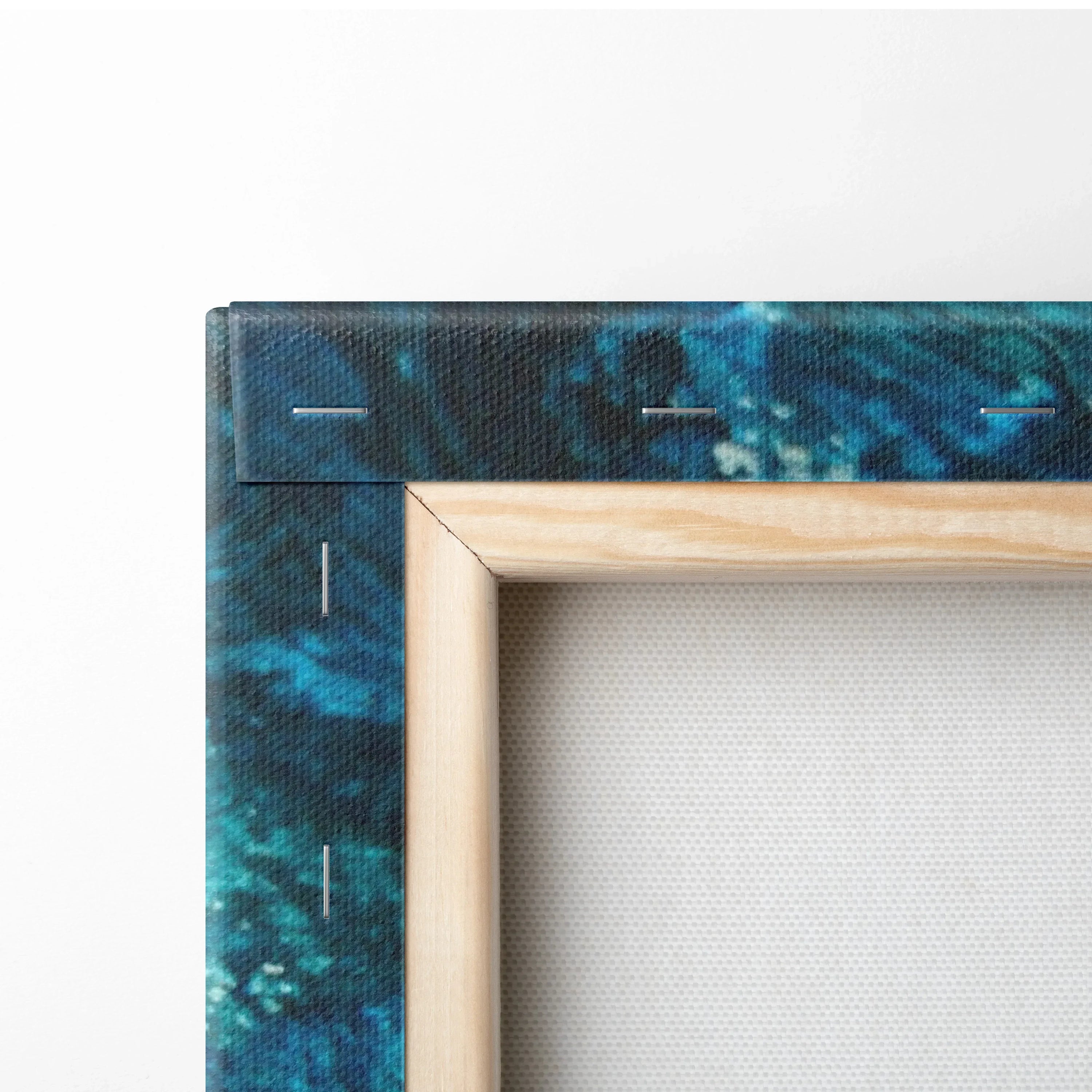 Close-up of vibrant blue and green abstract nature inspired canvas wall art corner with natural wood stretcher frame.