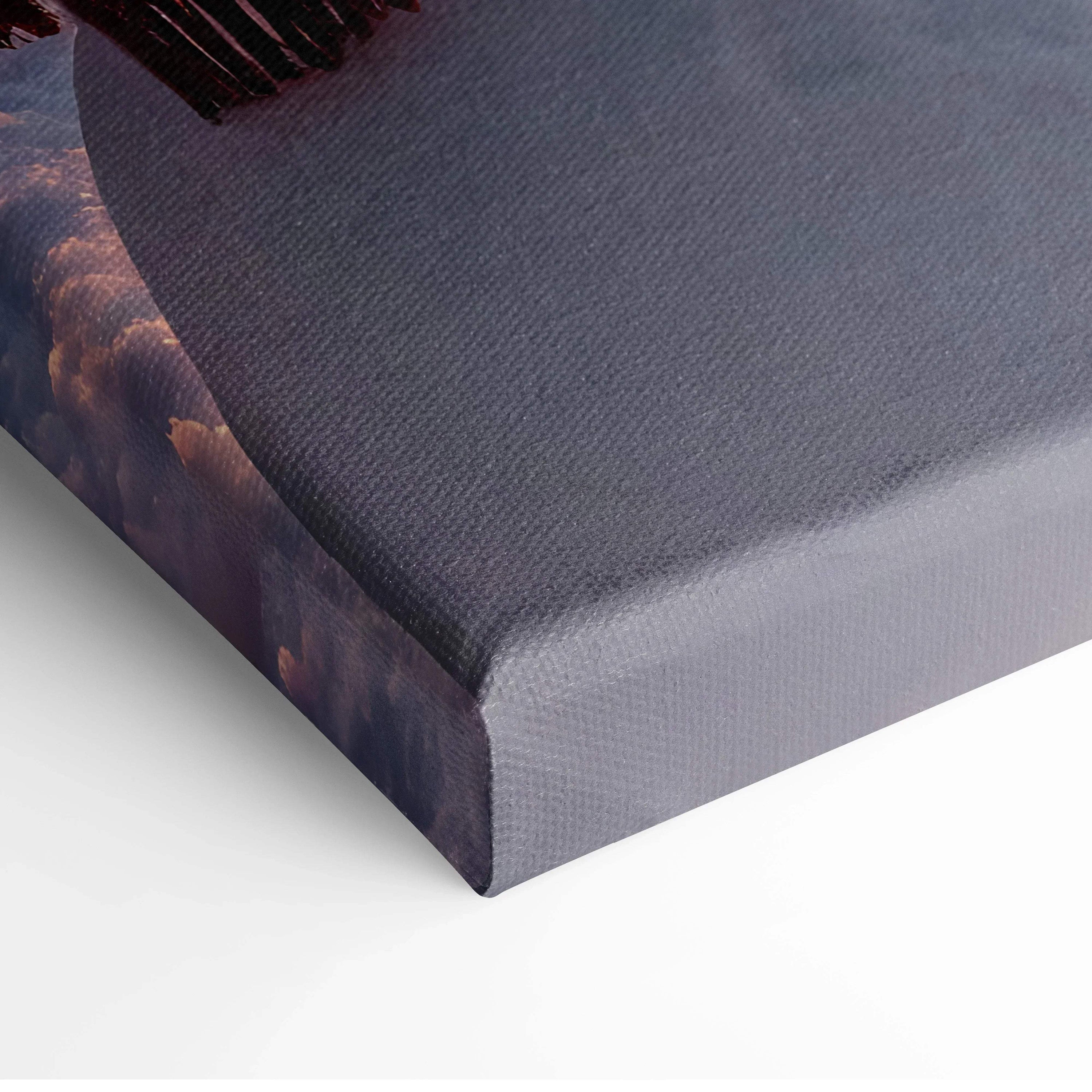 Corner close-up of wrapped canvas wall art with serene snowy landscape and soft purple hues.