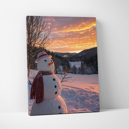 Canvas wall art featuring a snowman wearing a red scarf at sunset in a snowy landscape.