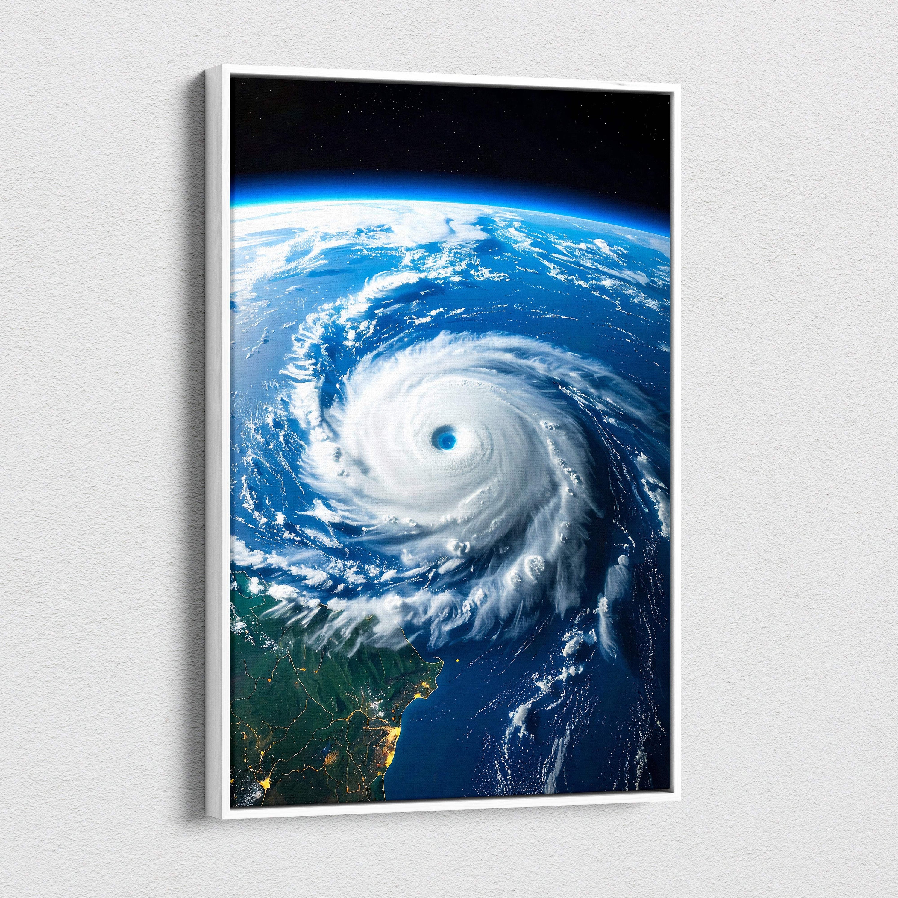 Framed hurricane from space canvas wall art featuring a swirling ocean cyclone eye in deep blues and whites