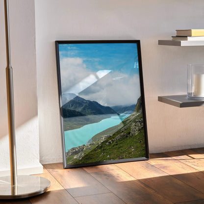 Majestic mountain landscape poster with turquoise lake and cloudy blue sky, vertical wall art print.