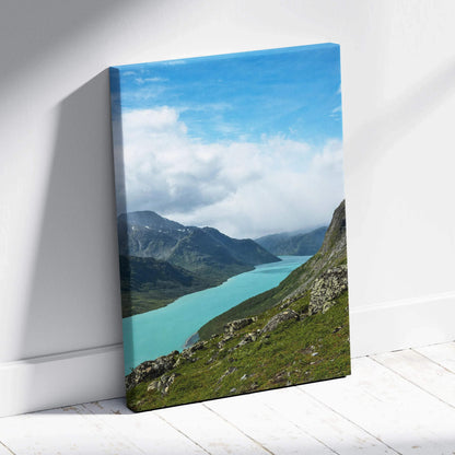 Mountain landscape canvas wall art featuring turquoise lake and green hills under a blue sky.