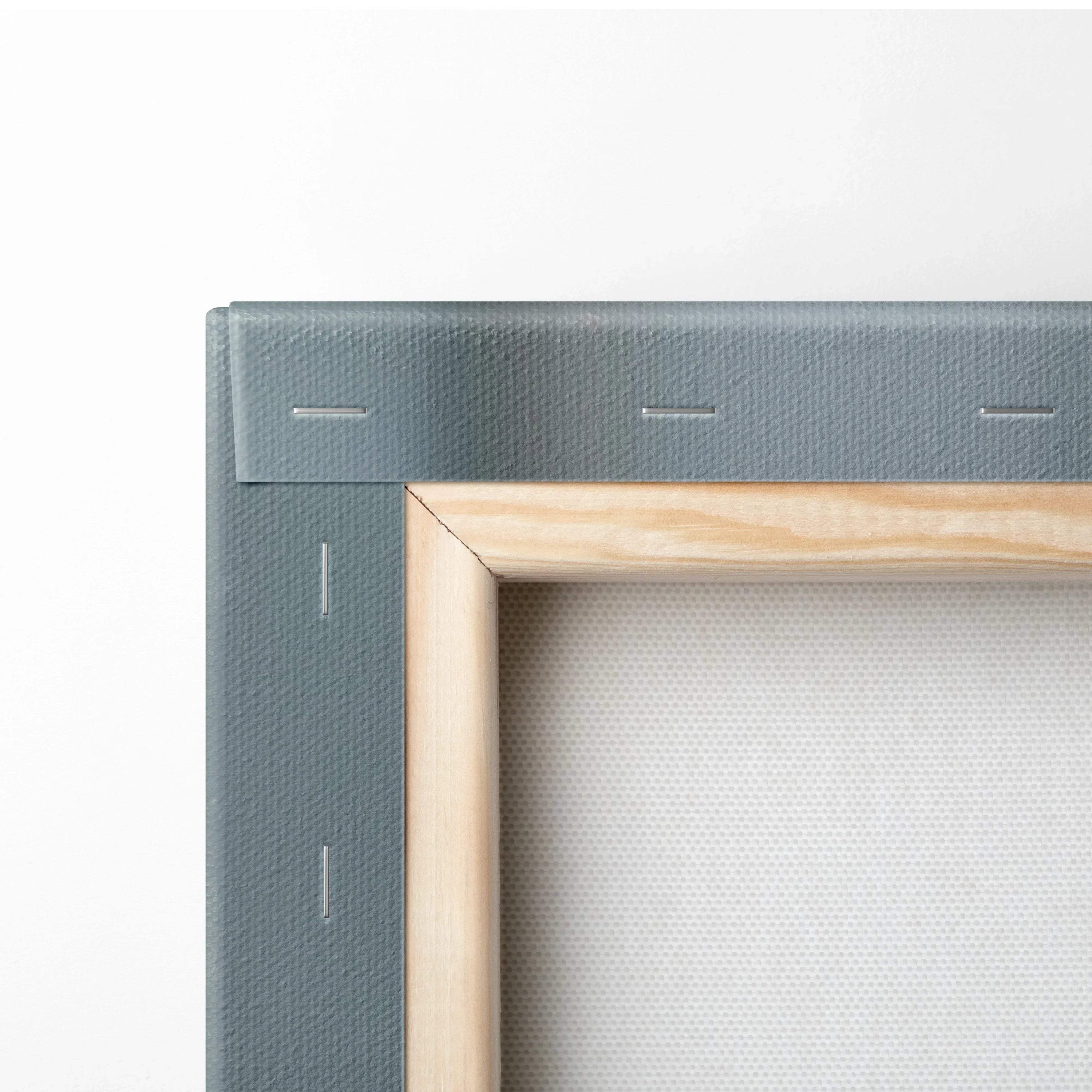 Close-up of wooden frame corner with gray canvas backing for wall art print.