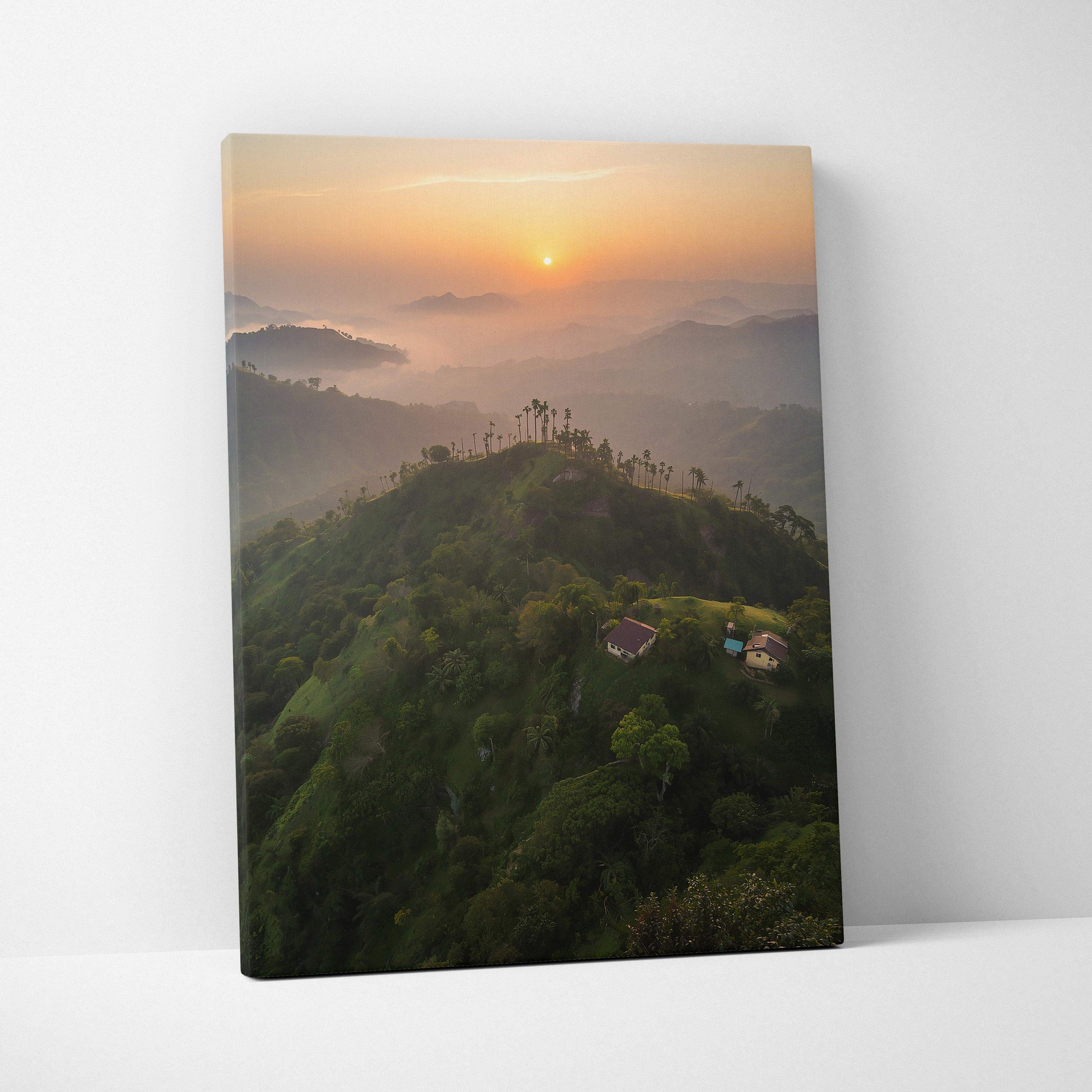 Canvas wall art featuring a serene mountain landscape at sunset with warm orange skies and misty hills.