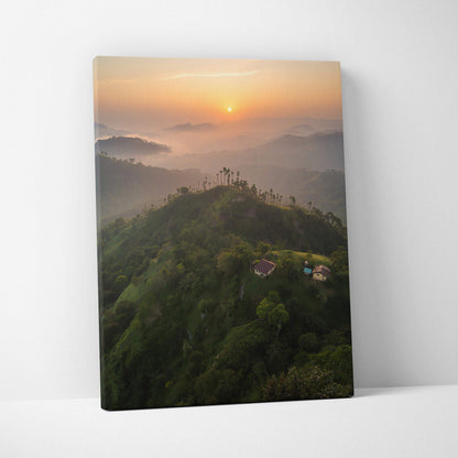 Canvas wall art featuring a serene mountain landscape at sunset with warm orange skies and misty hills.