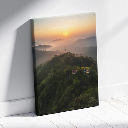 Canvas wall art of a serene mountain landscape at sunset with mist and warm light.