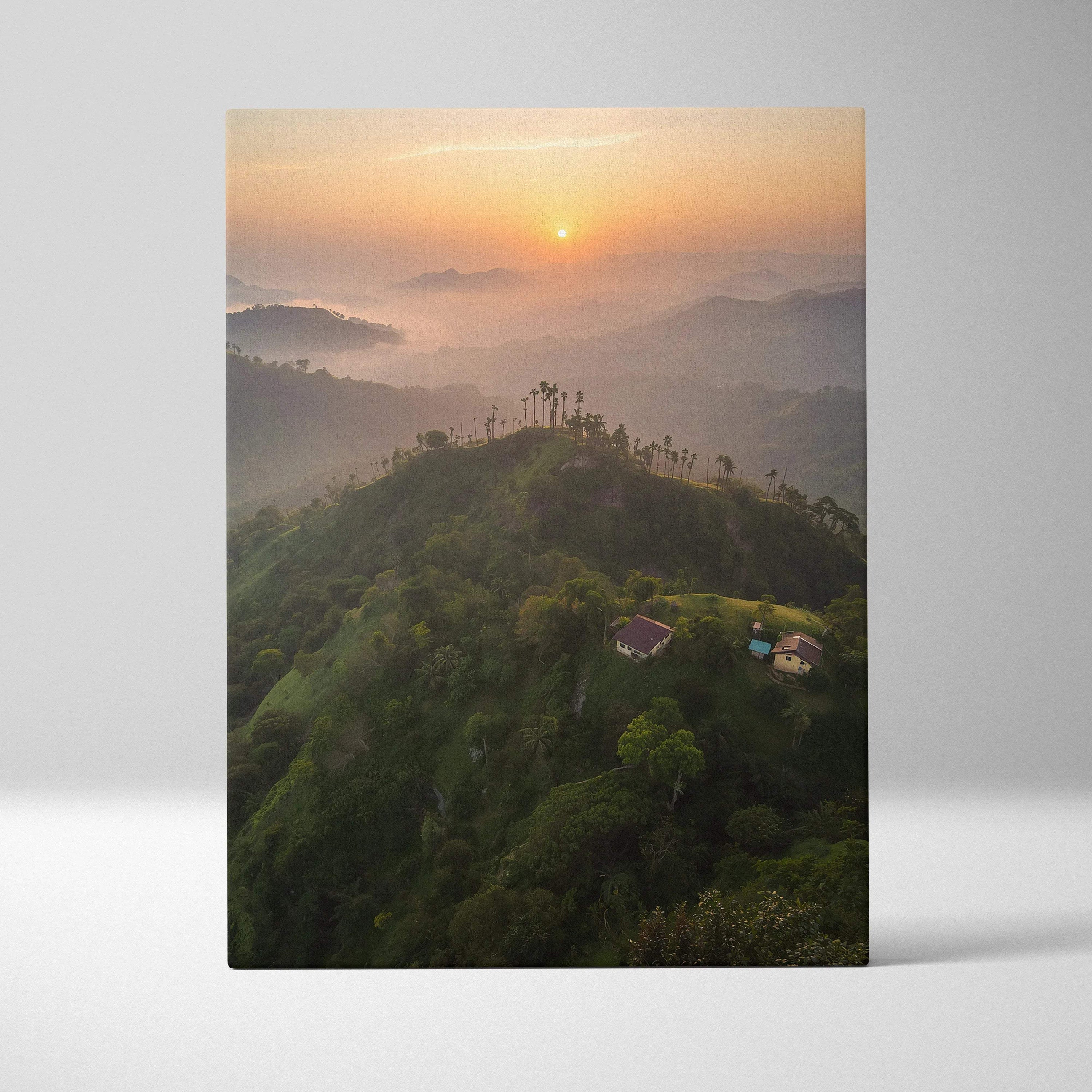 Vertical canvas wall art featuring misty green mountains at sunrise with warm orange sky.