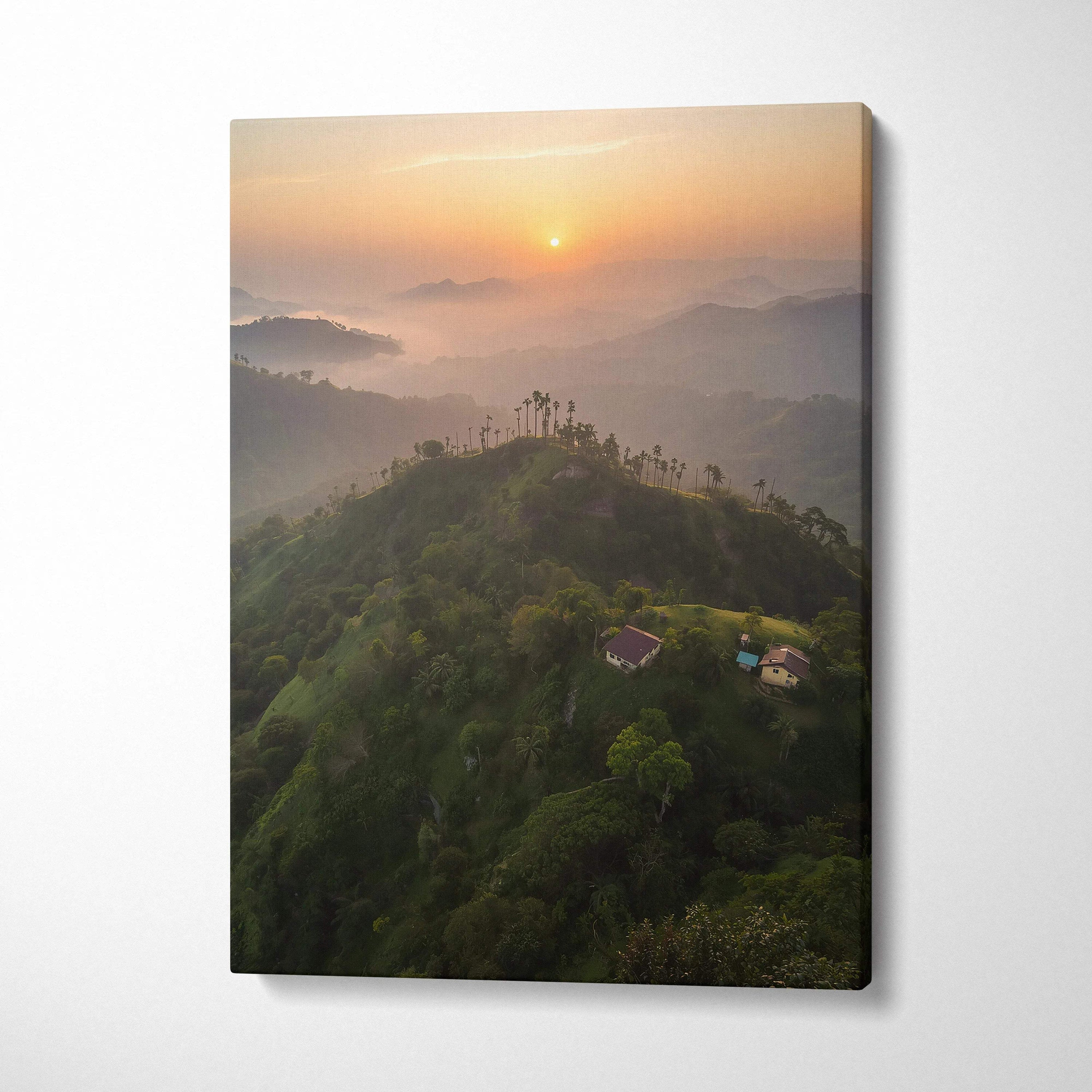 Canvas wall art featuring a misty mountain landscape at sunset with soft orange sky.