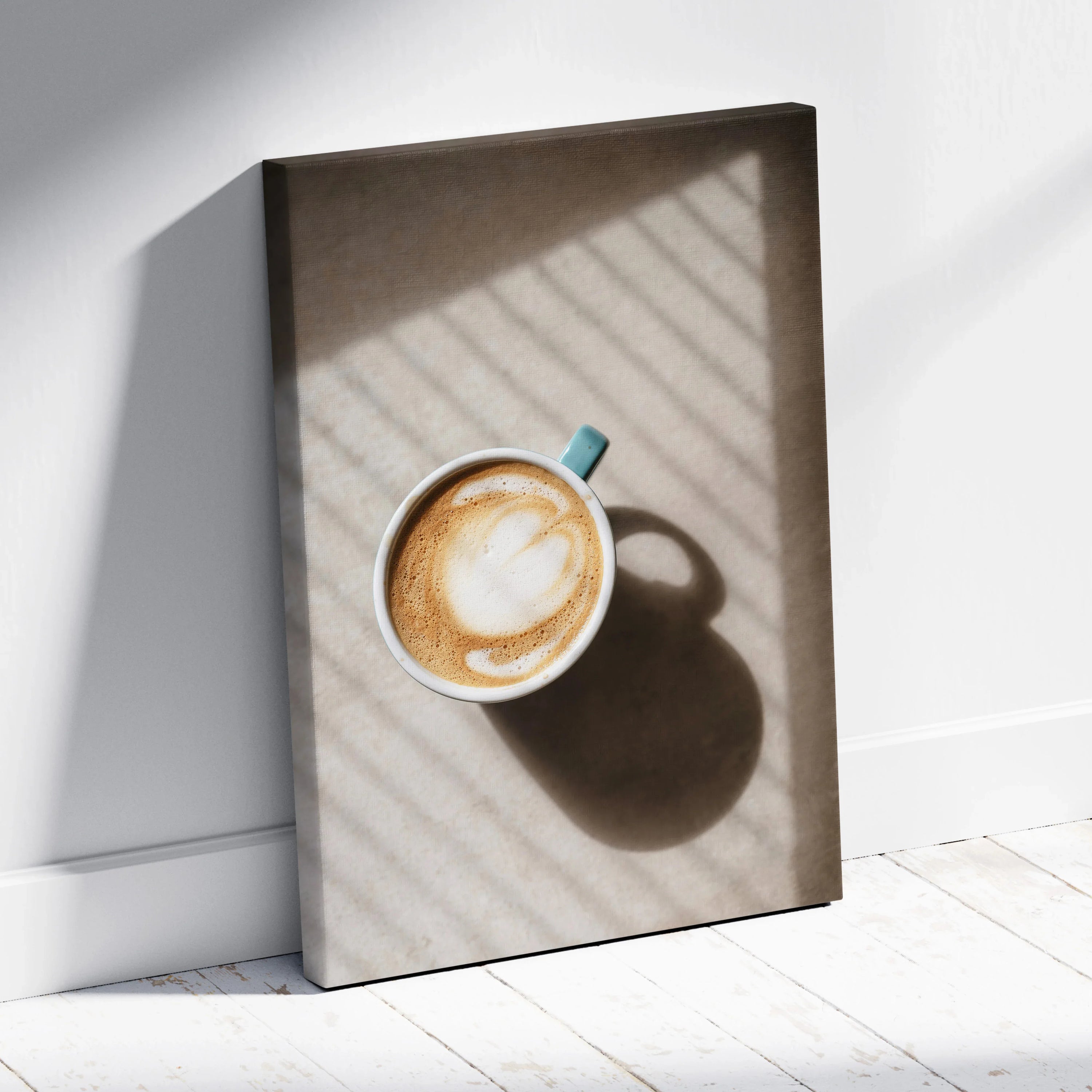 Canvas wall art featuring a top-down view of a coffee cup with latte art and soft shadow lines on a neutral background.