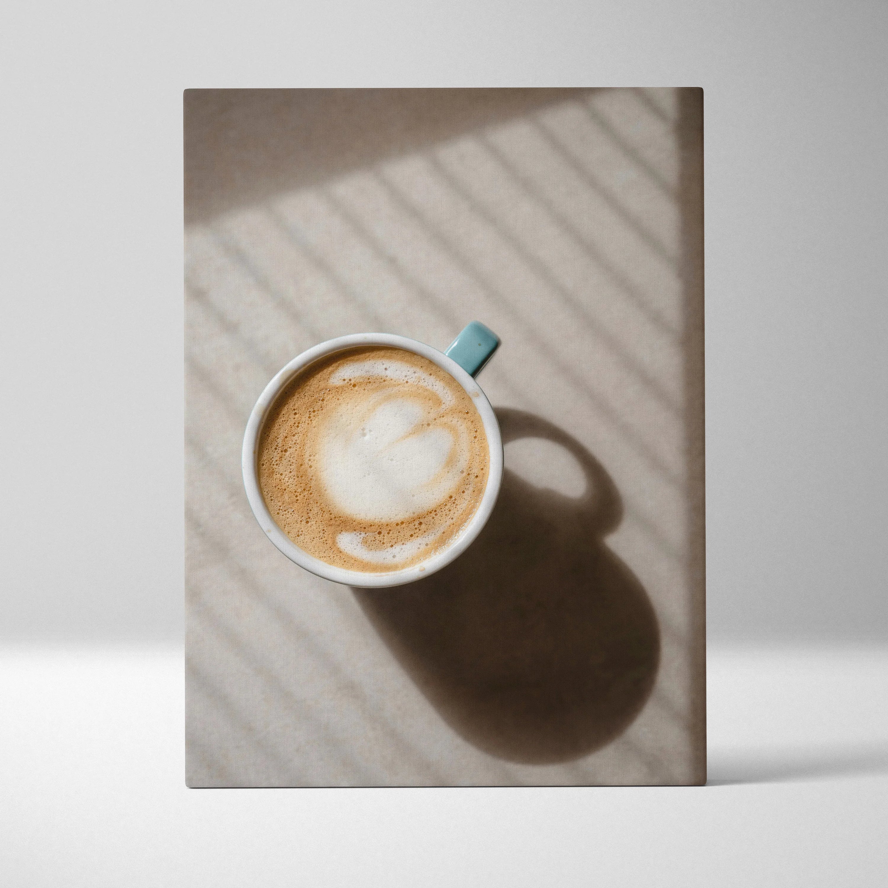 Vertical canvas wall art featuring a cozy coffee cup with latte art and soft shadows.