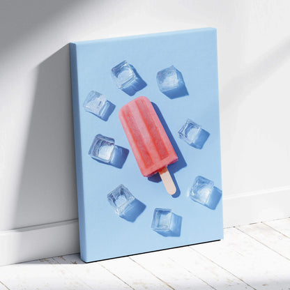 Vertical canvas wall art featuring a vibrant red popsicle surrounded by ice cubes on a light blue background.