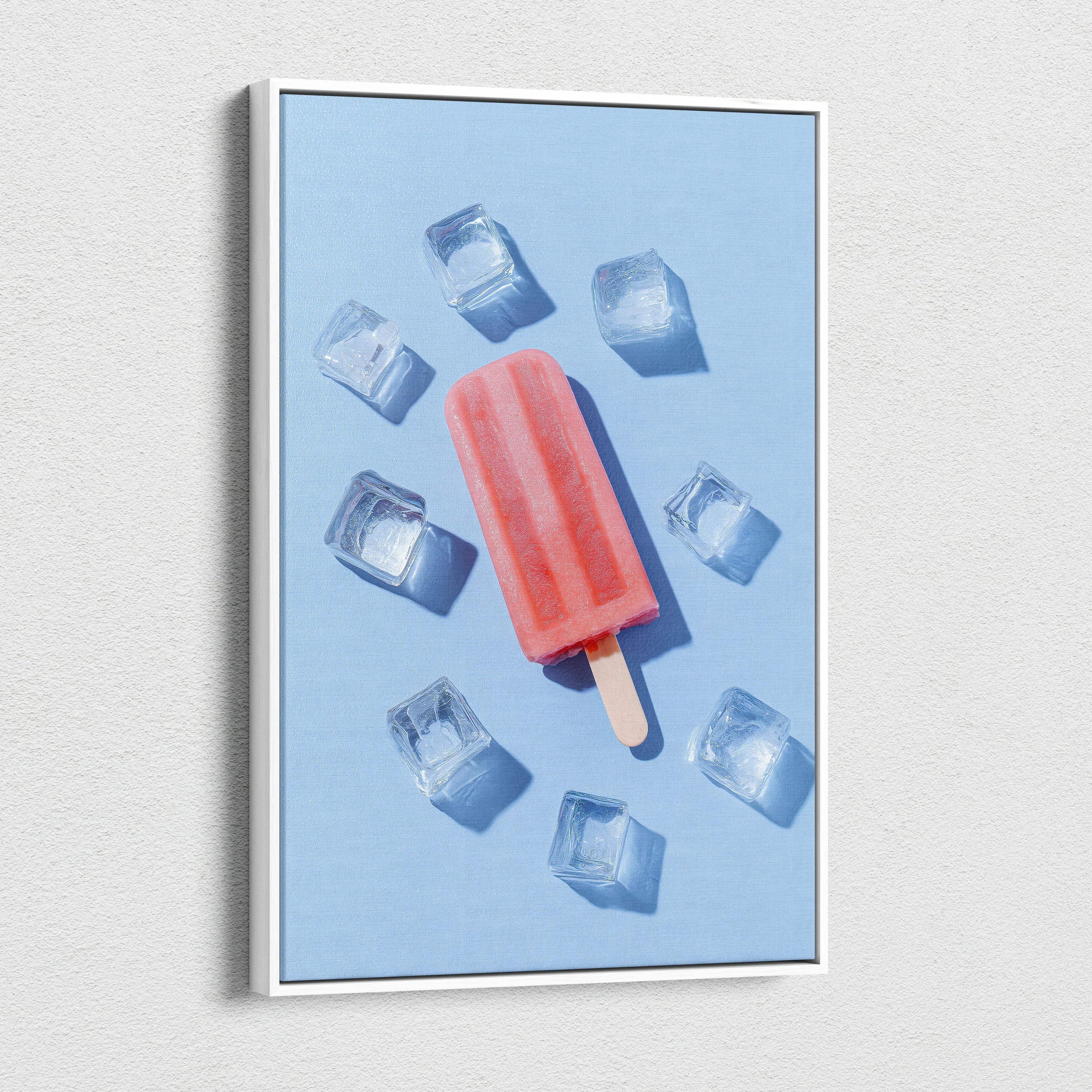 Canvas wall art featuring a vibrant red popsicle surrounded by ice cubes on a light blue background.