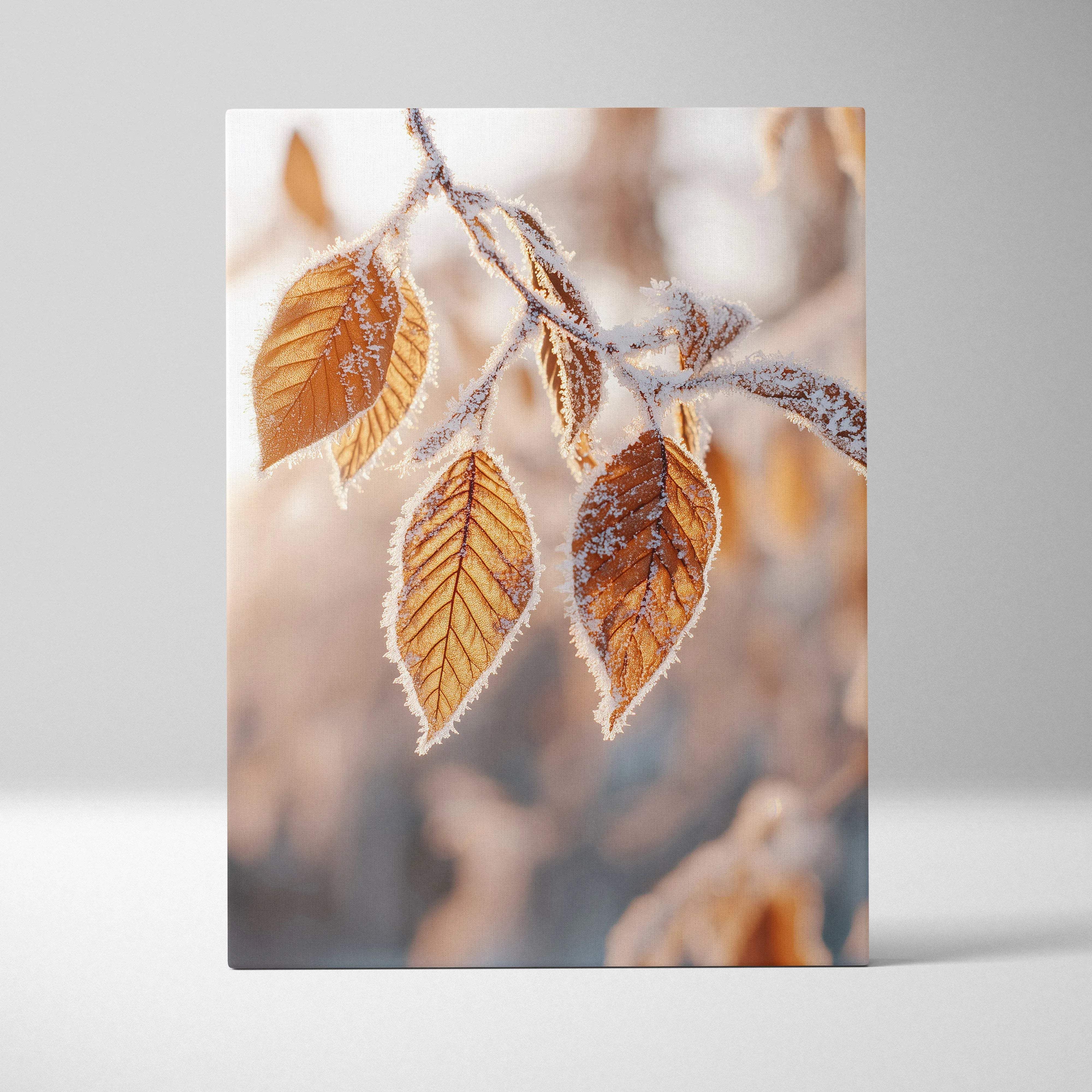 A rectangular canvas wall art featuring frost kissed golden brown autumn leaves on frosty branches in warm foliage tones
