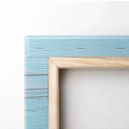 Close-up of light blue textured canvas stretched on wooden frame for wall art display.
