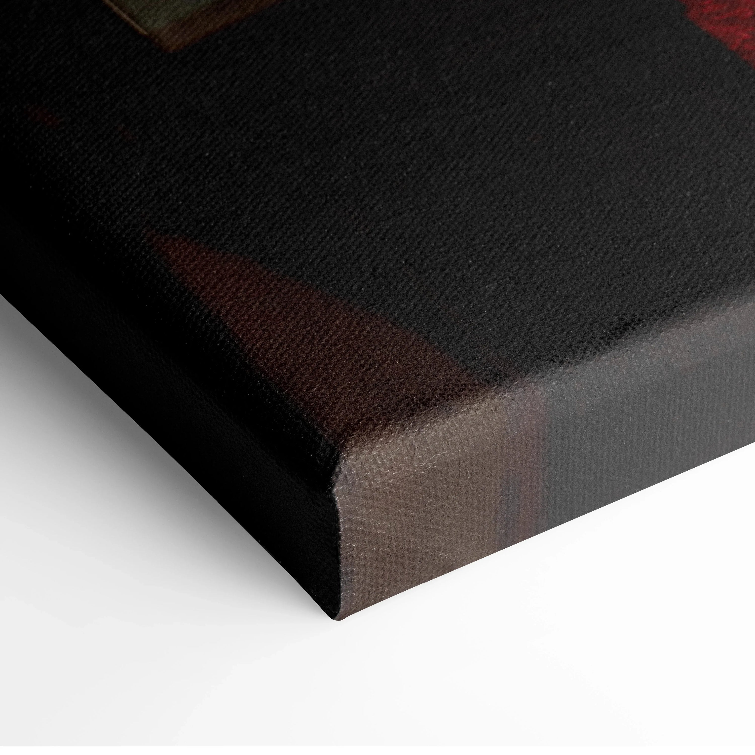 Close-up of black-edge canvas wall art with textured fabric and sharp corner wrapping.