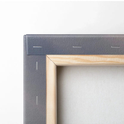 Close-up of wooden frame and stapled edge of a stretched canvas for wall art.