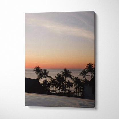 Golden sunset beach scene with silhouetted palm trees on canvas wall art.