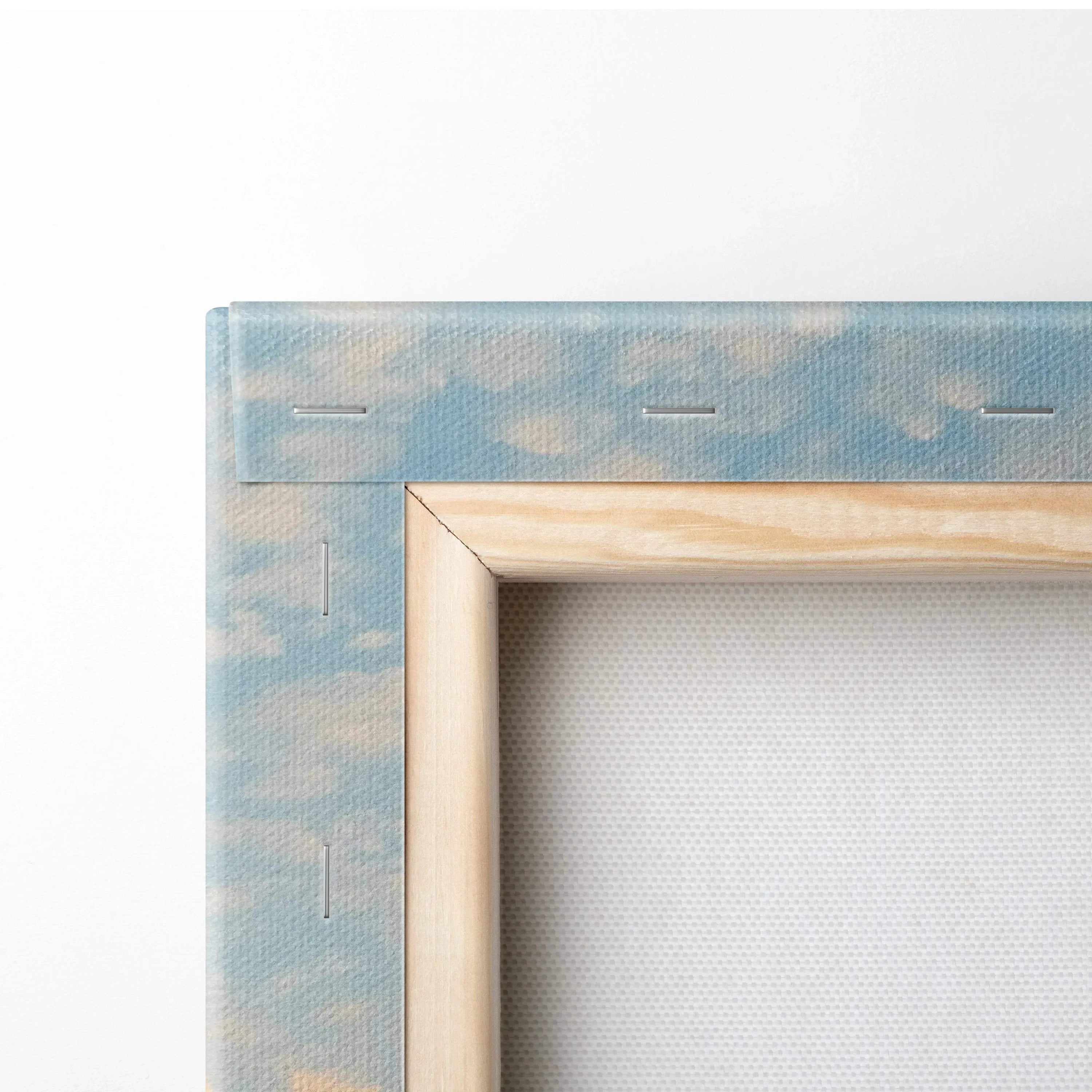 Close-up of stretched canvas corner with sky and cloud design wrapped around wooden frame for wall art.