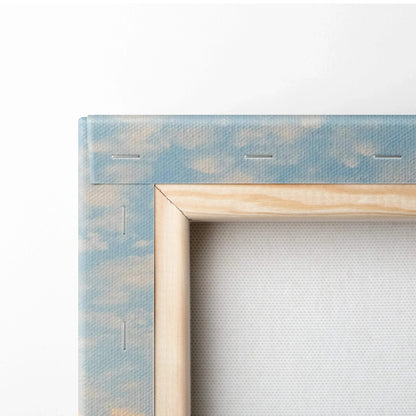 Close-up of stretched canvas corner with sky and cloud design wrapped around wooden frame for wall art.