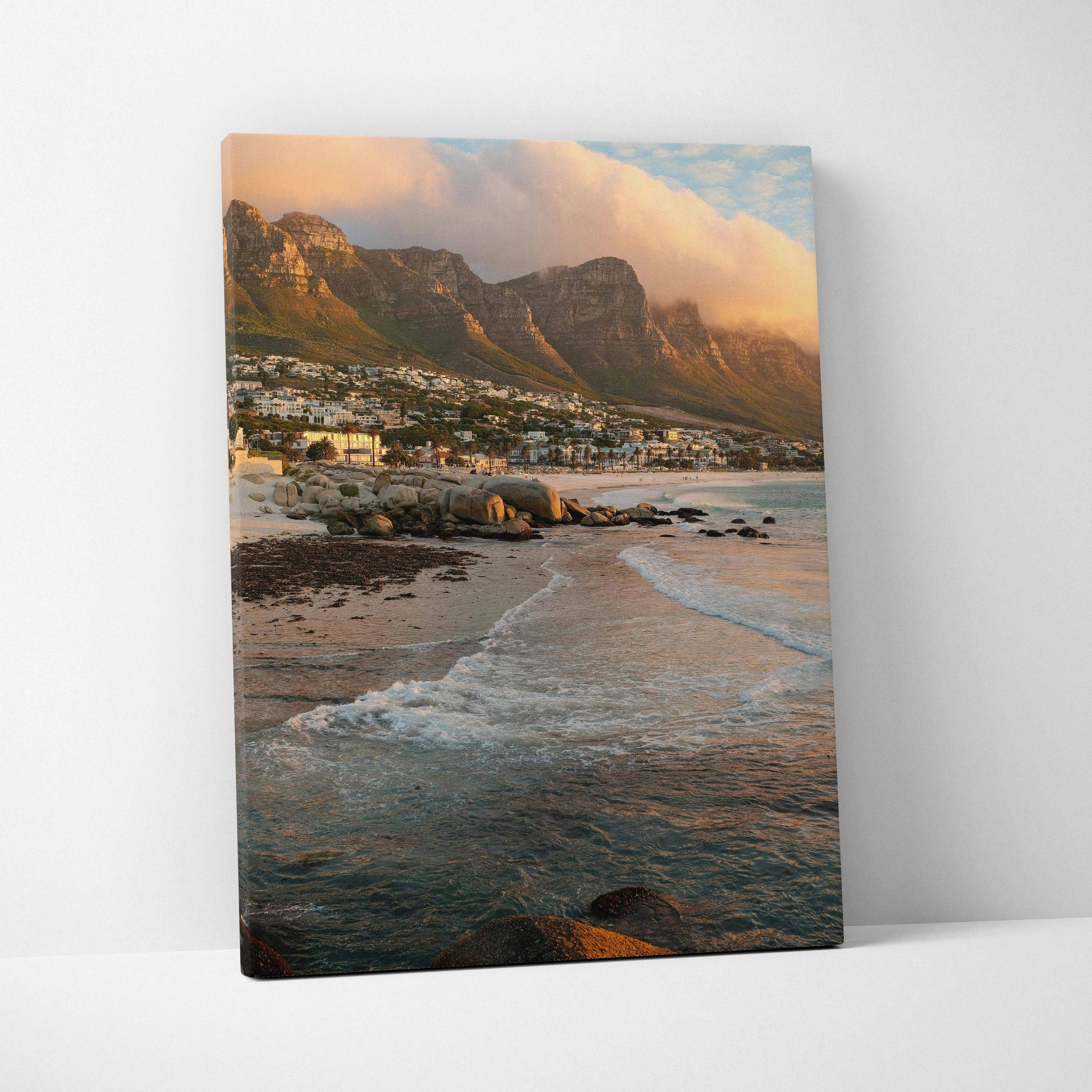Canvas wall art featuring majestic mountains and a beach at sunset with soft clouds and gentle waves.