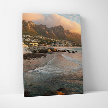 Canvas wall art featuring majestic mountains and a beach at sunset with soft clouds and gentle waves.
