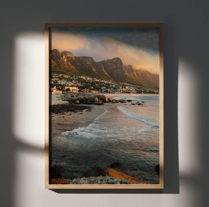 Vertical beach sunset poster with rocky shore and mountain backdrop wall art.