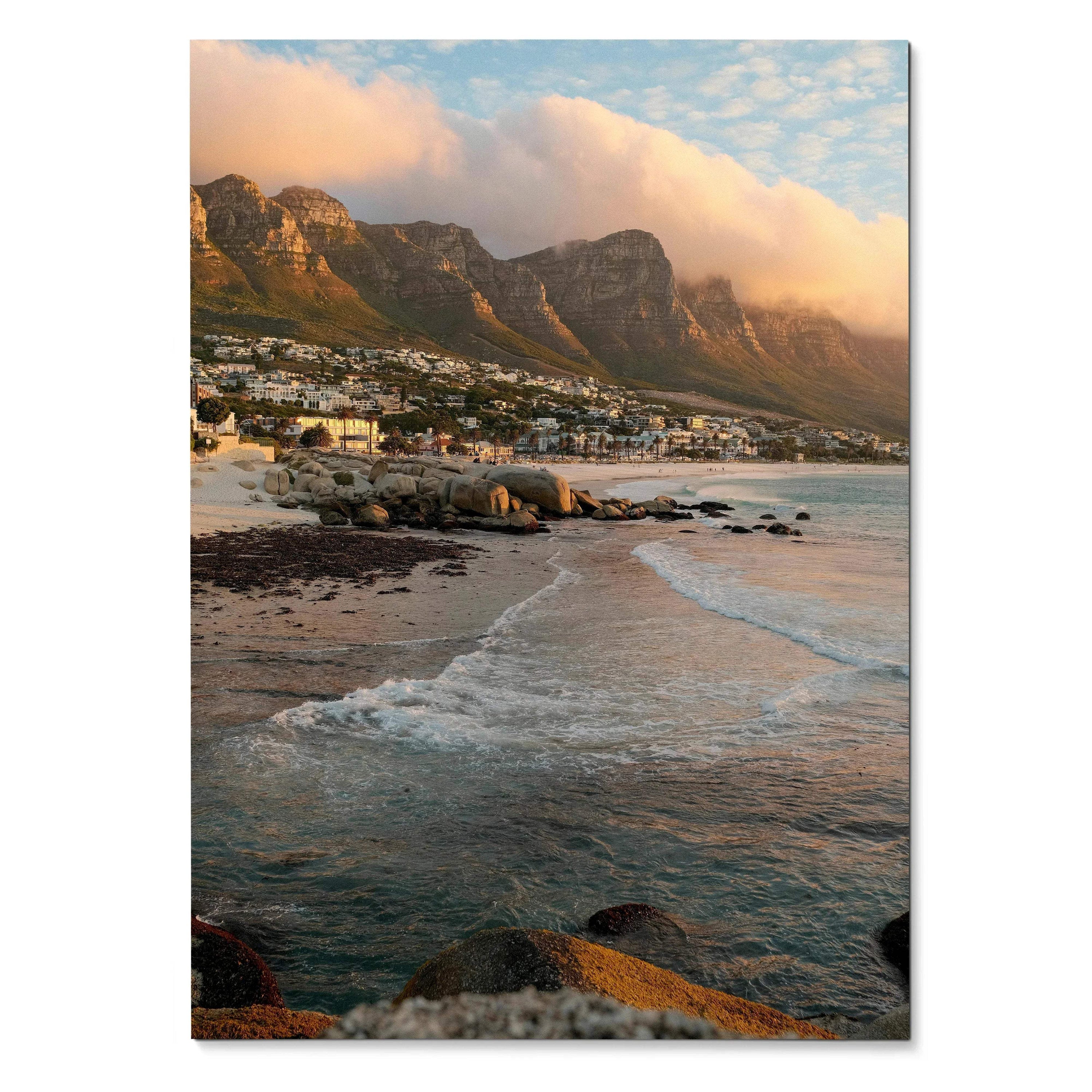 Vertical beach sunset poster with waves, rocky shore, and mountain backdrop wall art.