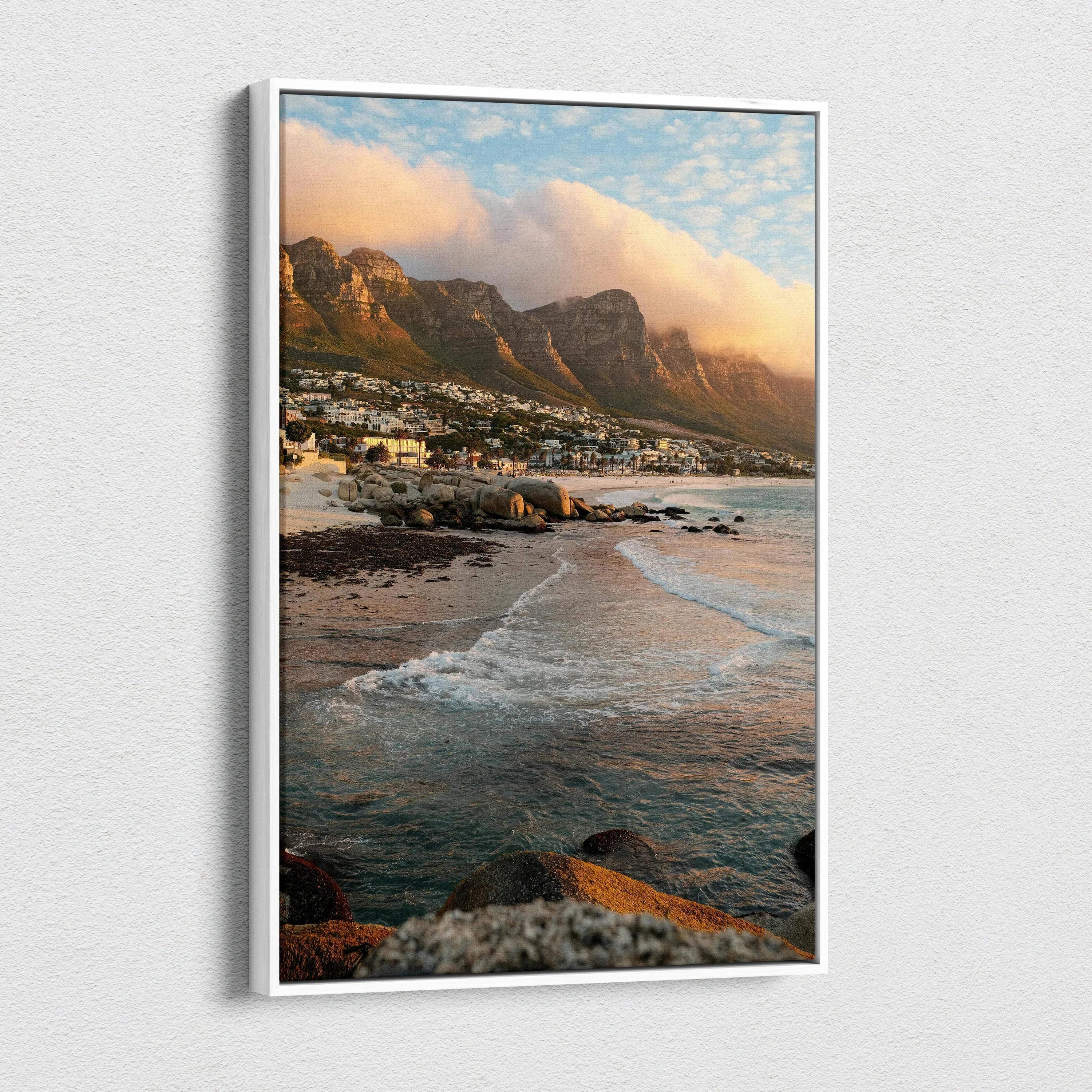 Vertical canvas wall art of mountains, beach waves, and colorful sunset sky.
