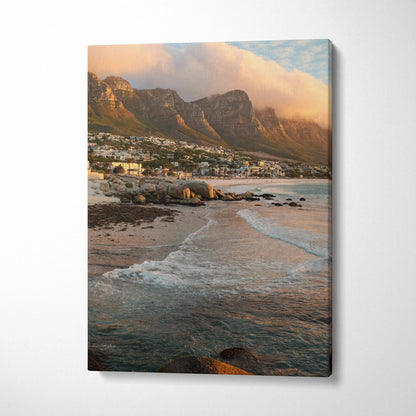 Vertical canvas wall art featuring a serene beach with gentle waves and majestic mountain backdrop at sunset.